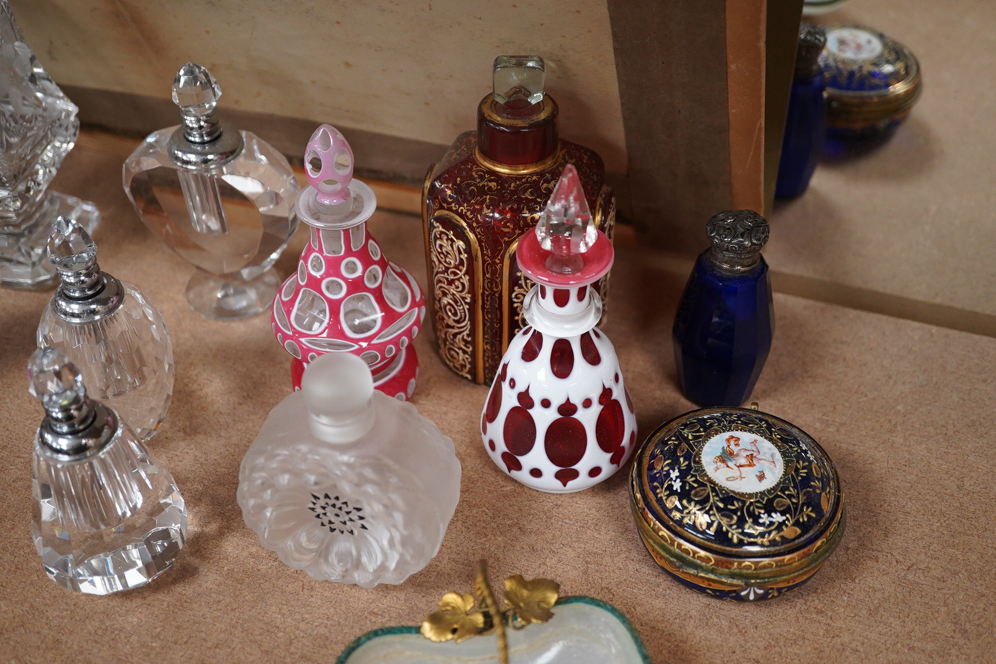 A collection of various glass scent bottles including a Lalique flower scent bottle and Bohemian examples, tallest 20.5cm. Condition - fair, some stoppers stuck